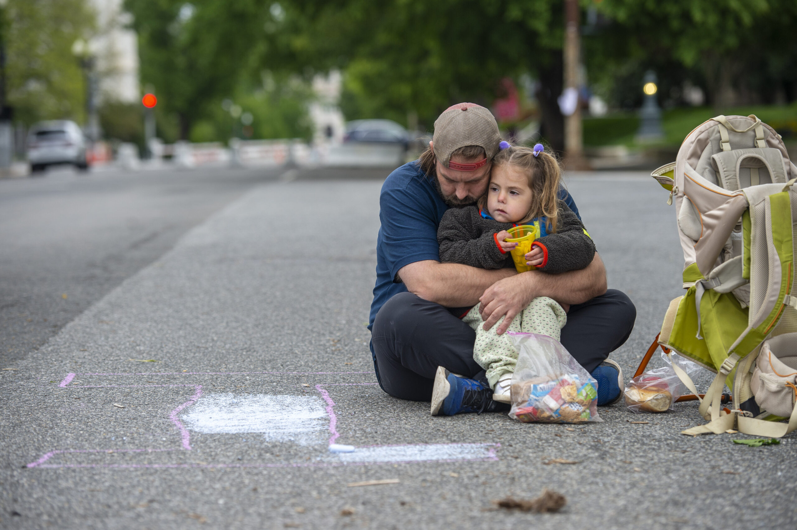 Image of parent with a child during an abortion rights demonstration