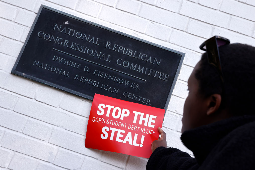 Photograph of student loan borrowers protest with sign reading "Stop the Steal!"