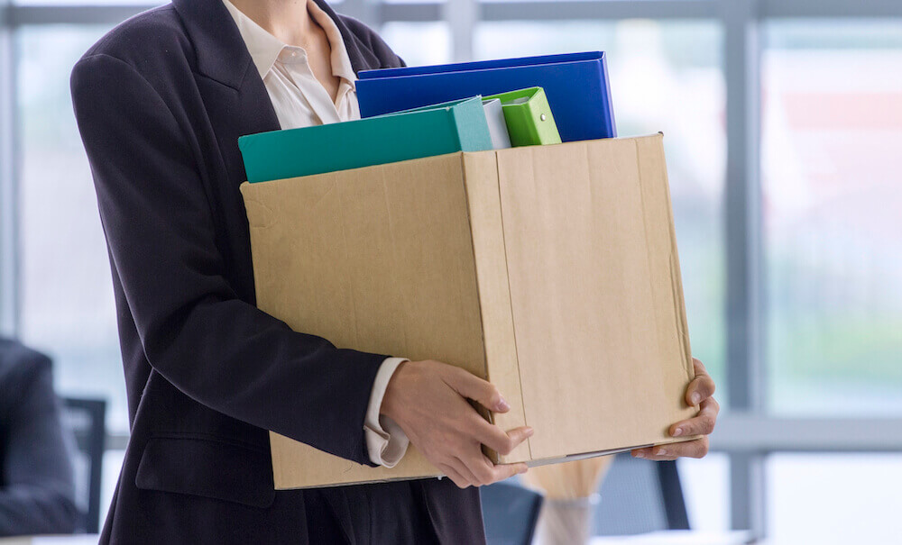 Image of a person clearing out their desk after losing their job.