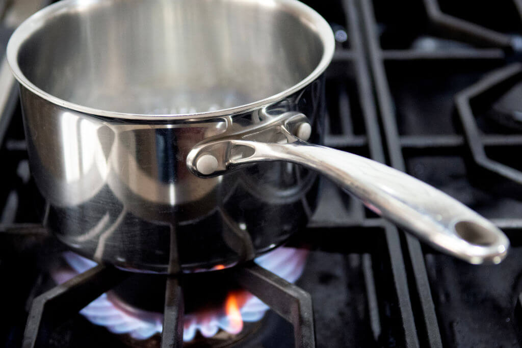 Image of a pot on a gas-burning stove.