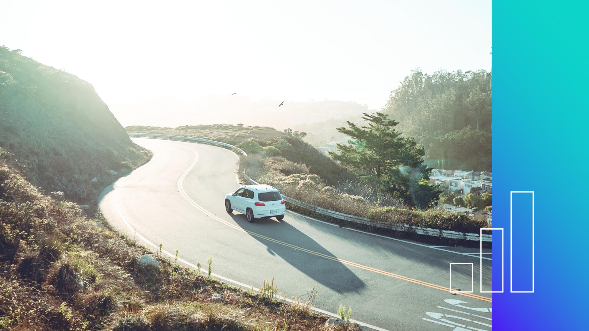 Image of a car driving on a road.