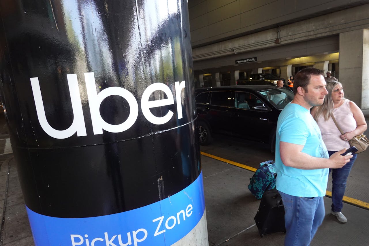 Photograph showing ride-hailing consumers at Uber pickup zone