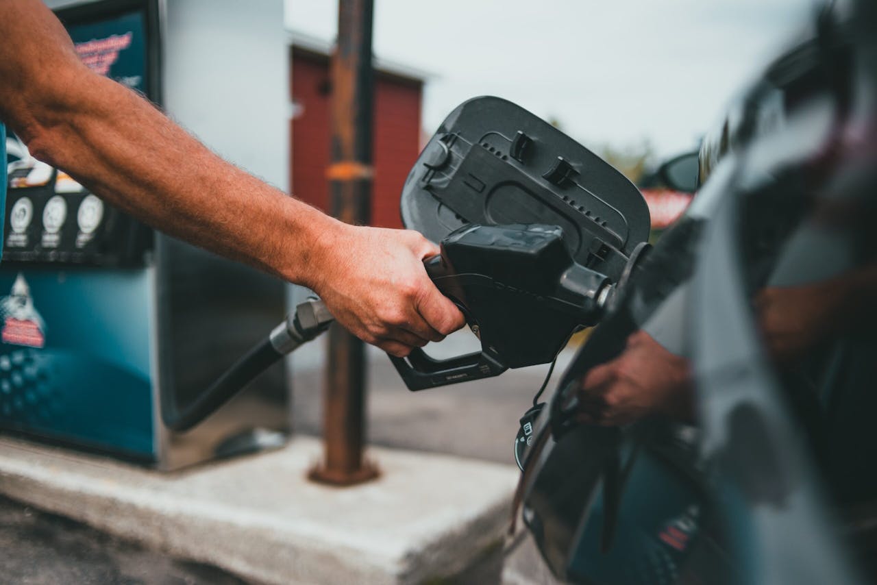 Image of a person putting gasoline in their vehicle.