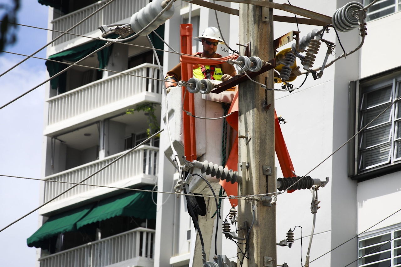 Photograph of utility crews completing repairs in Puerto Rico in the aftermath of Hurricane Fiona