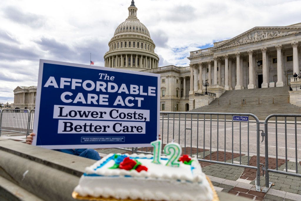 Photograph of sign in front of U.S. Capitol reading "The Affordable Care Act: Lower Costs, Better Care"
