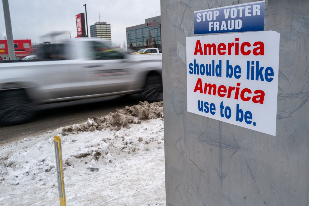 Image of a sign that says "Stop Voter Fraud" and "America should be like America used to be."