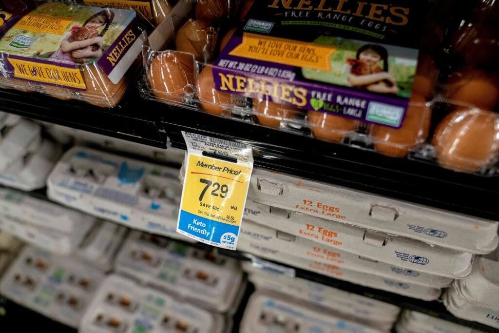 Photograph of eggs at a grocery store featuring price tag