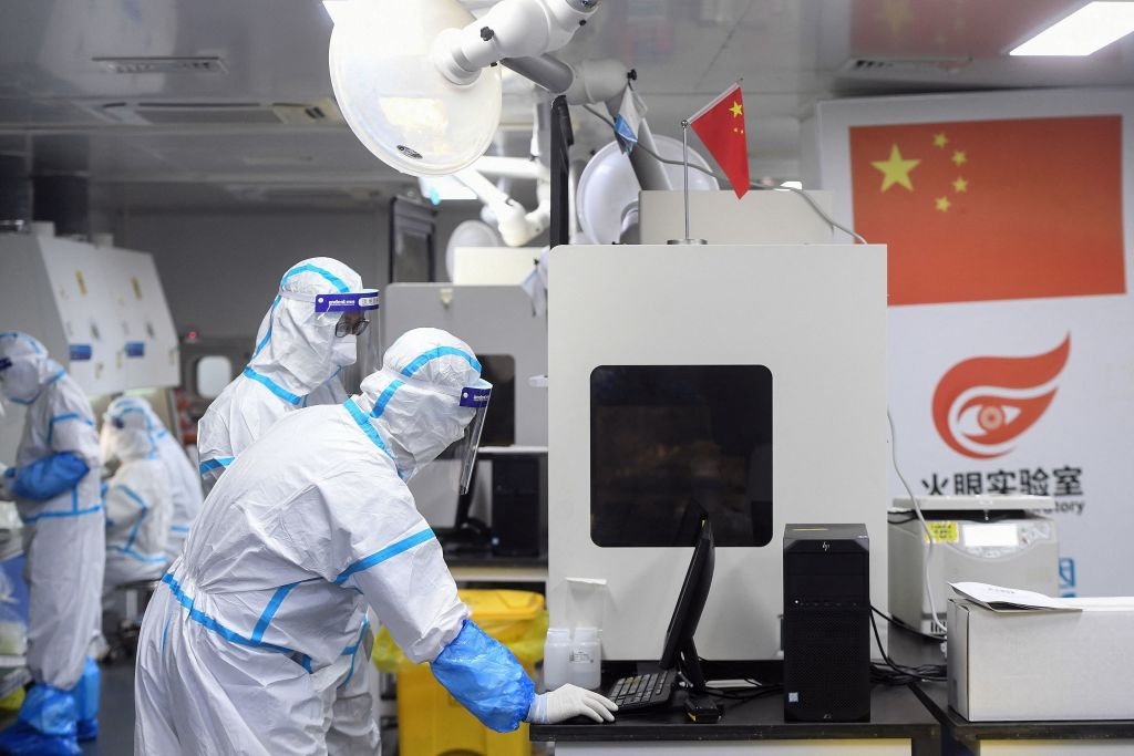 Image of technicians working on samples to be tested for COVID-19 at a laboratory in Wuhan, China on Aug. 4, 2021.