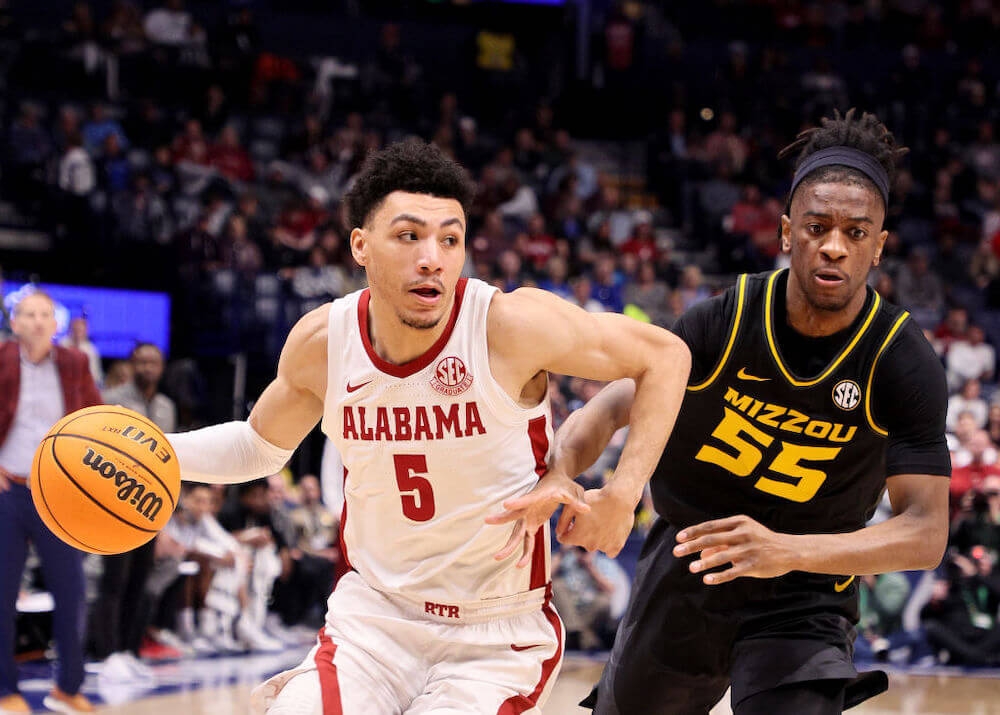 Image of Alabama's Jahvon Quinerly driving to the basket against Missouri's Sean East II during the Southeastern Conference Tournament ahead of the NCAA men's tournament.