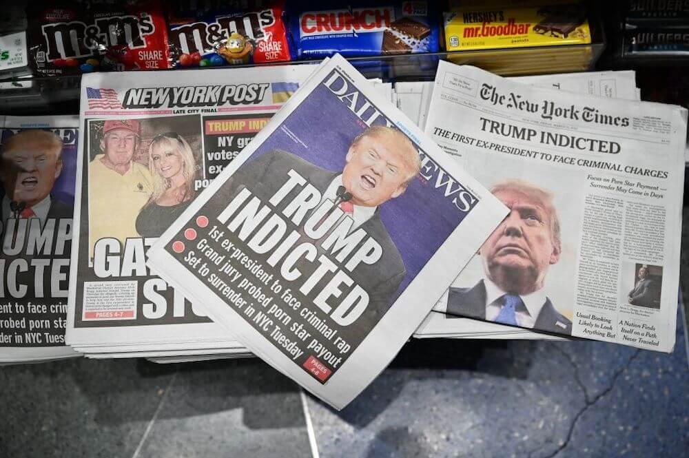 Image of newspaper front-pages featuring former President Donald Trump's indictment