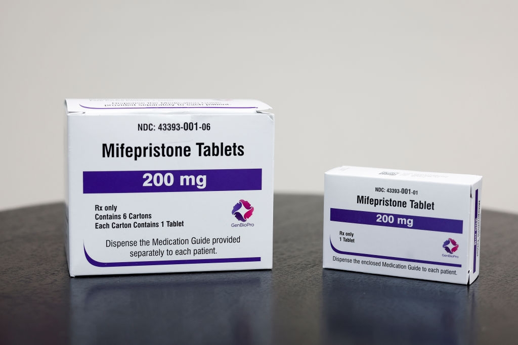 A photo illustration of packages of mifepristone tablets