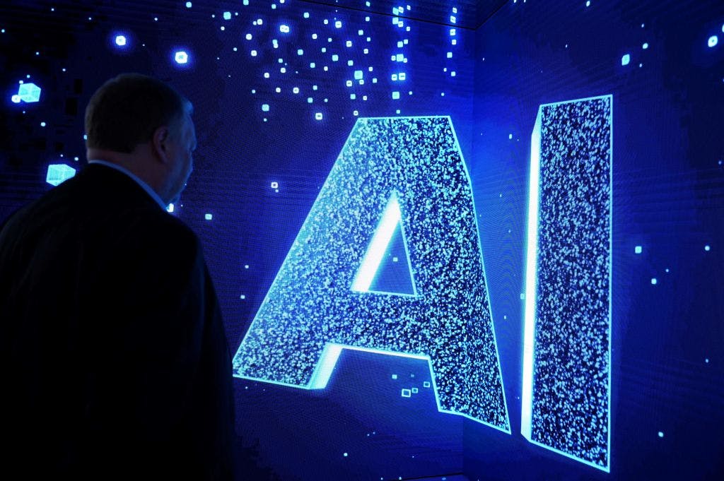 A visitor watches an AI sign on an animated screen