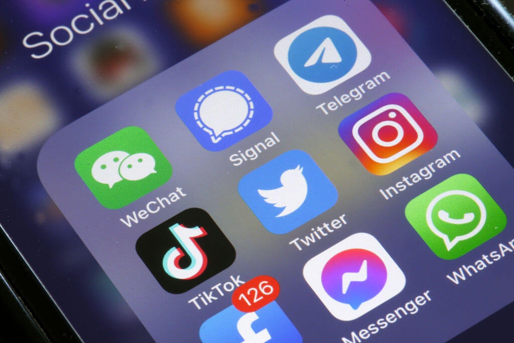 Photograph of smartphone featuring social media apps including TikTok